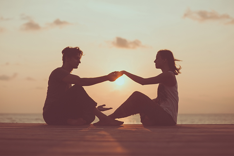 couple holding hands at sunrise